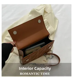 Internal capacity of brown quilted chain bag showing space for phone and wallet