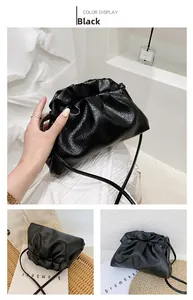 Detail of black cloud bag with lychee texture and slim strap in minimalist home setting