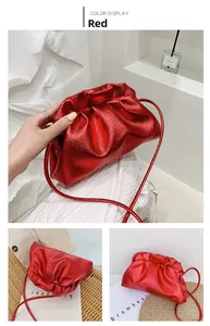 Detail of red metallic leather texture and ruched design on the crossbody cloud bag