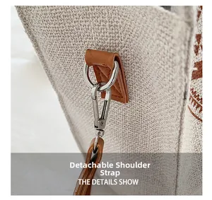 Detail showing the detachable shoulder strap and silver metal buckle on the canvas tote bag