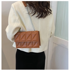 Detailed back view of a brown quilted leather crossbody bag with silver chain strap