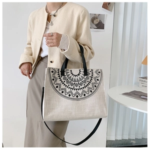 Detailed view of canvas tote bag featuring an intricate black mandala pattern design