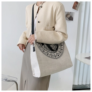 Detail of canvas tote bag with black mandala print and premium leather shoulder straps