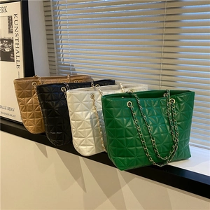 Quilted tote bags with gold chains in brown, black, white, and green colors