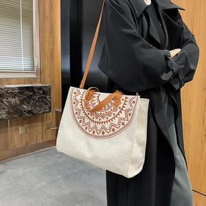 Minimalist canvas tote bag with tribal print and leather straps for office commute