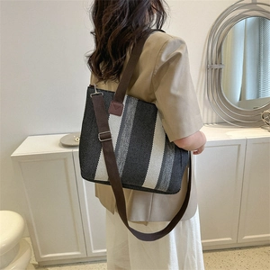 Minimalist striped canvas tote bag with adjustable straps for daily commuting