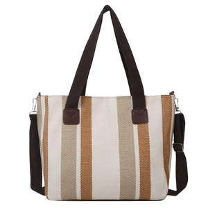 Vertical striped canvas tote bag with brown fabric handles and adjustable shoulder strap