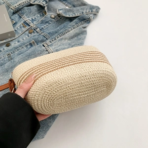 Detailed view of the fine woven texture and brown stripes on this stylish crossbody bag