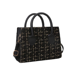 Classic black tweed handbag with gold thread details and black faux leather handles
