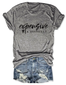 Flat lay showing details of grey t-shirt with print and distressed denim shorts texture