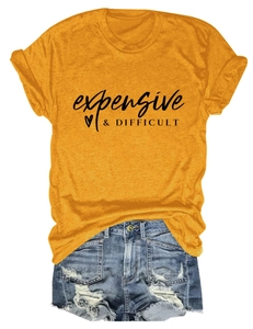 Flat lay of mustard yellow t-shirt with expensive & DIFFICULT print and denim shorts