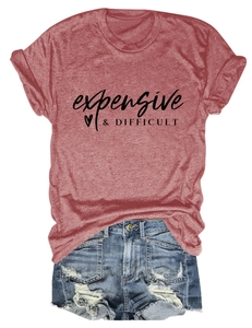 Flat lay of a brick-red crewneck T-shirt with text print and distressed denim shorts
