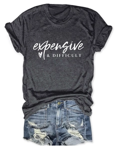 Flat lay of charcoal t-shirt with white expensive difficult print and denim shorts