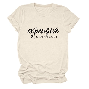 Close-up of beige t-shirt featuring expensive difficult black text print and rolled sleeves