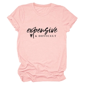 Detail view of the expensive & DIFFICULT text print and heart icon on a pink cotton T-shirt
