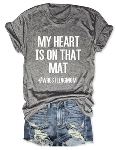 Flat lay of gray heather wrestling mom t-shirt with blue distressed denim shorts