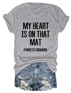 Detail of grey crewneck tee with wrestling mom slogan and distressed denim shorts
