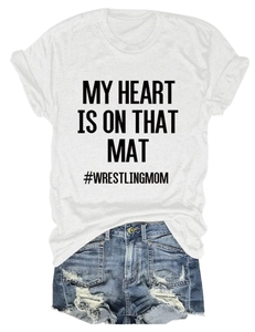 Flat lay of a white crewneck T-shirt with black My Heart Is On That Mat print