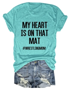 Detail of teal crew neck T-shirt with wrestling mom slogan and ripped denim shorts