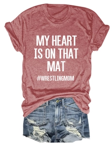 Flat lay of a red wrestling mom print t-shirt and distressed denim shorts outfit