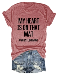 Flat lay of red My Heart Is On That Mat T-shirt and distressed denim shorts