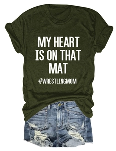 Detail of olive green t-shirt with My Heart Is On That Mat print and distressed denim shorts