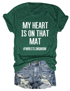 Flat lay of green short-sleeve T-shirt and ripped denim shorts with wrestling mom print