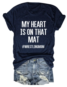 Detail view of MY HEART IS ON THAT MAT print on navy T-shirt with ripped denim shorts