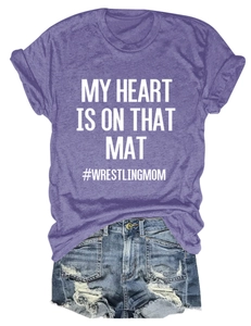 Flat lay of purple wrestling mom t-shirt paired with distressed denim shorts