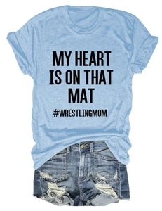 Flat lay detail of blue cotton T-shirt with MY HEART IS ON THAT MAT text and denim shorts