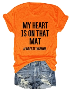 Detail of orange wrestling mom t-shirt paired with distressed blue denim shorts