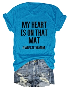 Close-up of bright blue My Heart Is On That Mat T-shirt and ripped denim shorts set