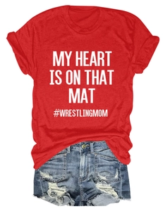Detail of red T-shirt with My Heart Is On That Mat print and distressed denim shorts