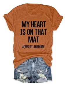 Detail of crew neck T-shirt with My Heart Is On That Mat print and denim shorts