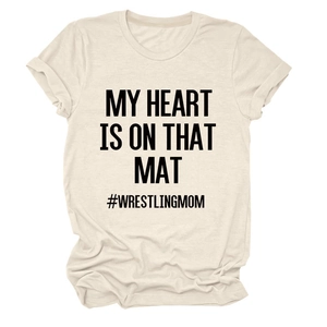 Detail of cream t-shirt showing MY HEART IS ON THAT MAT slogan and wrestling mom hashtag