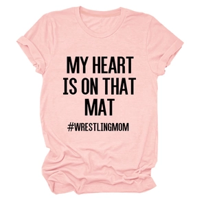 Detailed flat lay of pink wrestling mom t-shirt with black text on cotton fabric