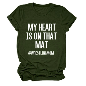 Close-up of My Heart Is On That Mat lettering and Wrestling Mom tag on green T-shirt