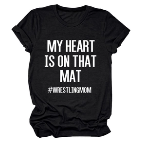 Flat lay of black cotton T-shirt featuring My Heart Is On That Mat white typography