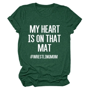 Detail showing the white text print and fabric texture of the green wrestling mom t-shirt