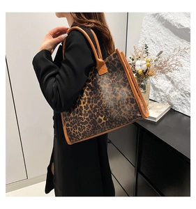 Vue détaillée du grand sac cabas à motif léopard avec bordures en cuir marron sur modèle