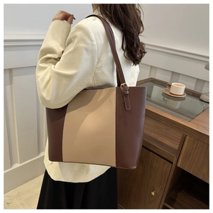Detail of vintage color-block tote bag with adjustable metal buckle on shoulder strap