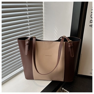 Detail of two-tone tote bag with adjustable golden buckle and Fashion & Bag text