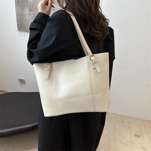 Minimalist cream tote bag with gold lettering and adjustable straps for women