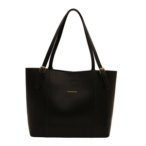 Minimalist black faux leather tote bag with gold hardware and shoulder straps for women