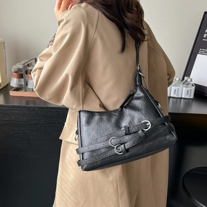 Retro black faux leather tote bag with silver buckle straps in a half-moon shape