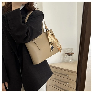 Chic khaki leather tote bag for women with decorative silk scarf and golden logo detail