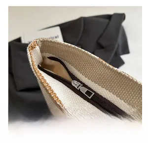 Detail view of smooth silver zipper and contrast weave fabric on the canvas tote bag