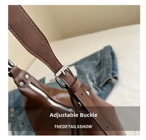 Detail of adjustable silver buckle on brown leather strap for tote bag crossbody bag