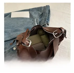 Detailed interior view of brown leather hobo bag showing large storage capacity