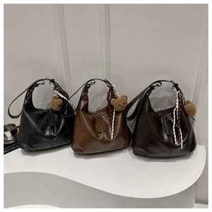 Three minimalist faux leather hobo bags in black, tan and brown with cute bear charms